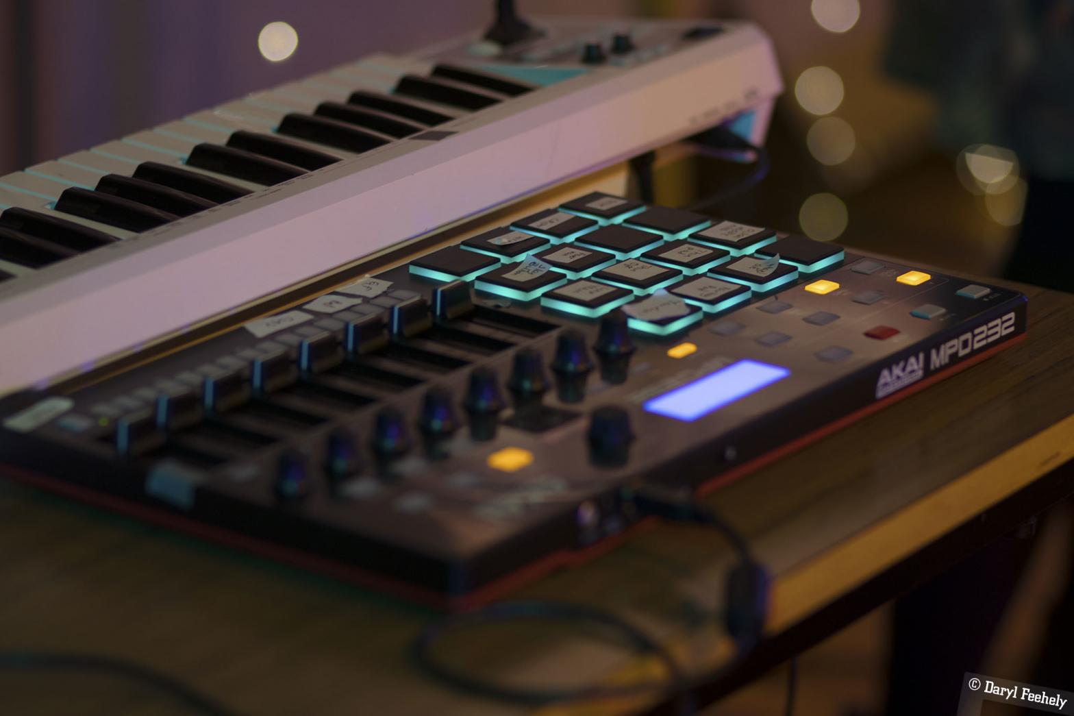 a black Akai music controller with blue glowing buttons (Daryl Feehely)