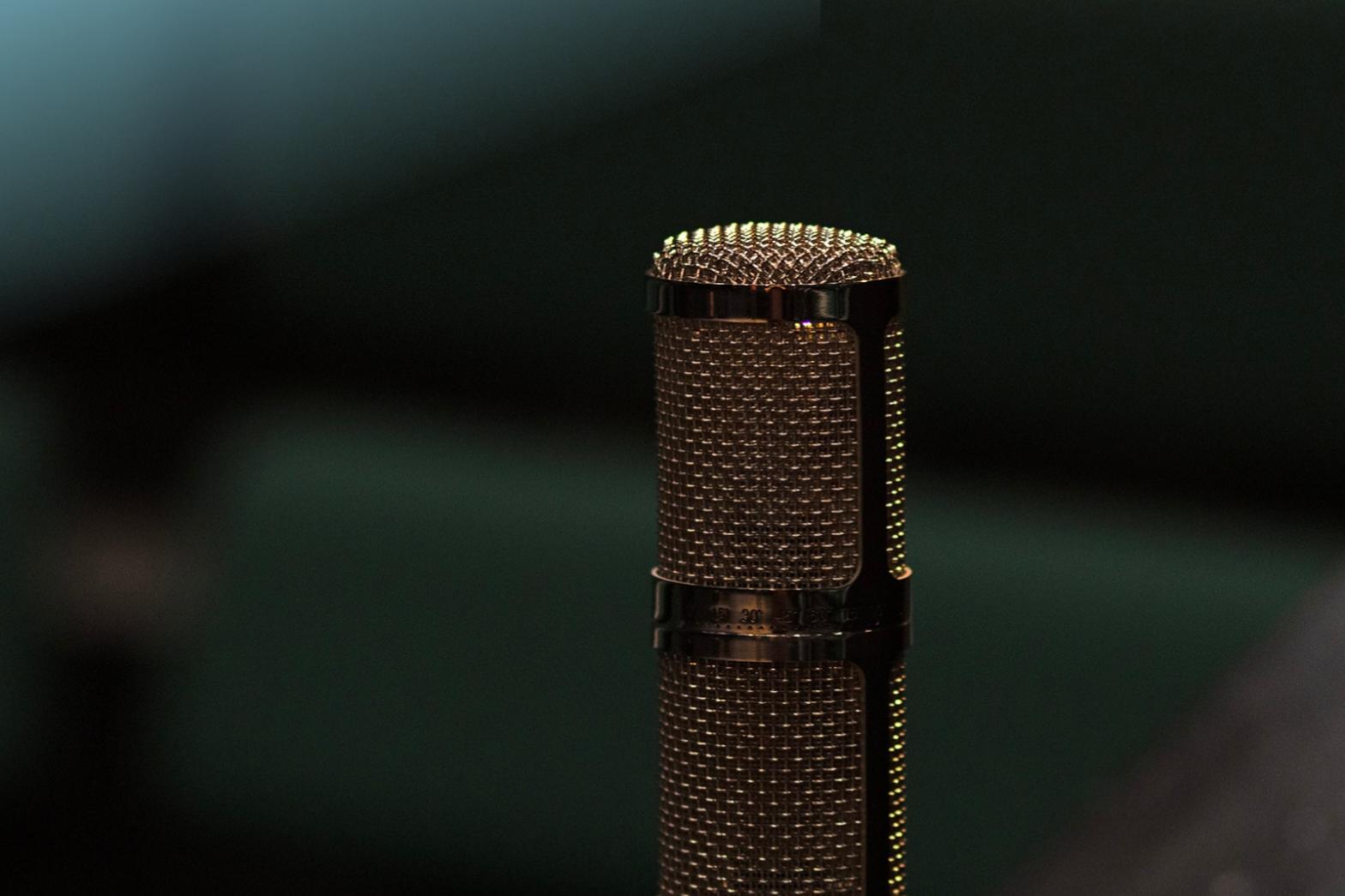 Single microphone on a dark background