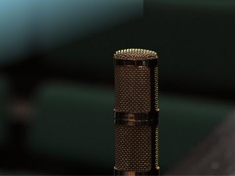 Single microphone on a dark background